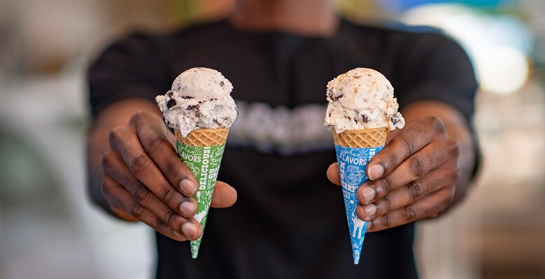 hand holding out ice cream cones